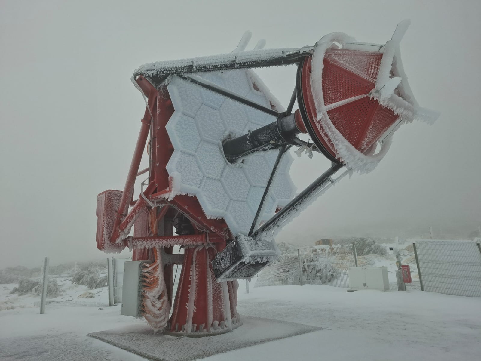 The ASTRI-3 telescope covered in snow and ice. The ASTRI-3 telescope covered in snow and ice.